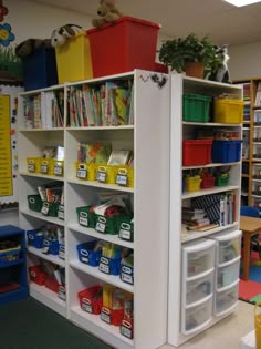 a room with several shelves and bins filled with children's toys in it