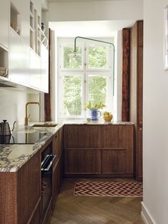 a kitchen with wooden cabinets and white walls