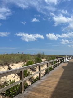 a wooden walkway leading to the beach