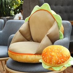 a hamburger shaped pillow sitting on top of a chair