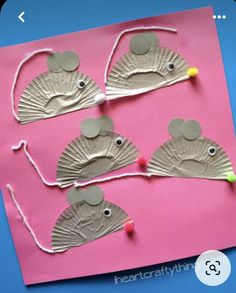 paper plate mouse craft for kids on a blue and pink background with string attached to it