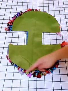 someone is making a paper mache shaped like the letter e