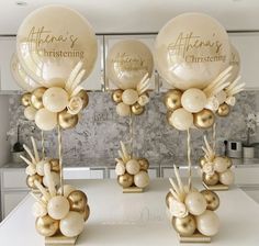 three gold balloons are on top of each other in the shape of flowers and leaves