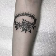 a black and white tattoo with a rose on it