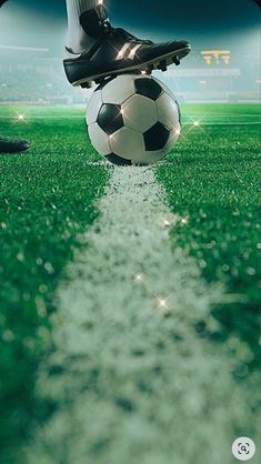 a person standing on top of a soccer ball