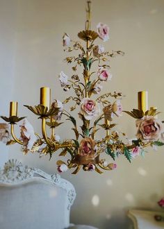 a fancy chandelier with pink flowers on it