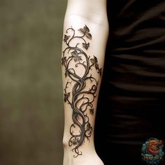 a woman's arm with an intricate tattoo design on the left side of her arm