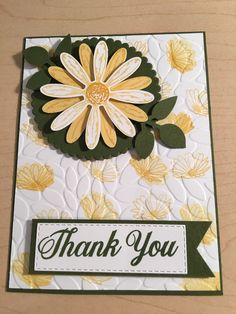 a thank you card with yellow and white flowers