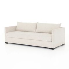 a white couch with two pillows on it