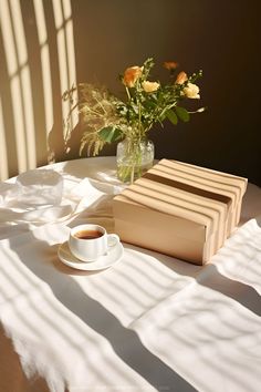 A book and a cup of tea on a table in a sunny bedroom setting. Quiet Moments