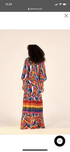 a woman in a colorful dress is looking back