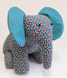 an elephant made out of fabric sitting on top of a table