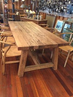 a large wooden table sitting on top of a hard wood floor