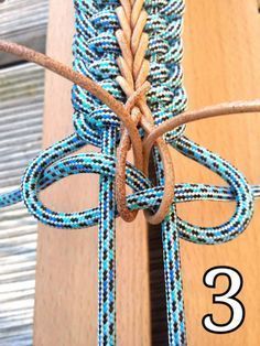 a close up of a piece of rope with the number 3 attached to it on a wooden surface