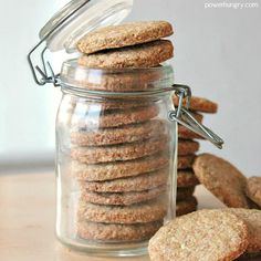 a jar filled with cookies sitting on top of a wooden table