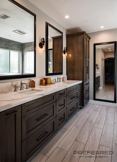 a large bathroom with double sinks and mirrors