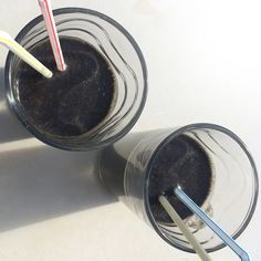 two cups with different colored straws in them