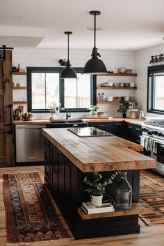 a kitchen with an island in the middle and lots of counter space on one side