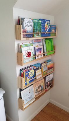 the bookshelf is filled with children's books on it and has wooden crates holding them