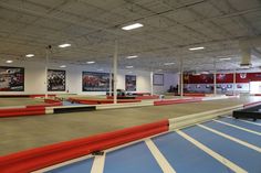 an empty indoor trampoline course with blue and red lines on the ground,