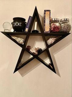 a star shaped shelf with various items on it