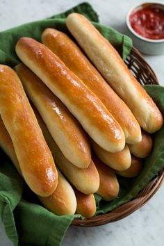 a basket filled with breadsticks sitting on top of a table