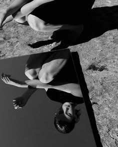 a woman in a bathing suit laying on the ground