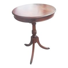 a small wooden table with an oval top