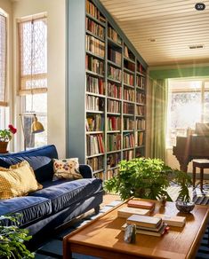 a living room filled with furniture and lots of books