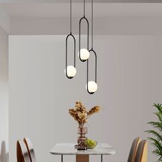 a dining room table with chairs and a vase filled with flowers