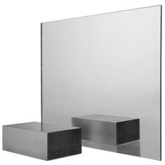 two square mirrors sitting next to each other