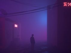 a person standing in the middle of a foggy street with power lines and telephone poles