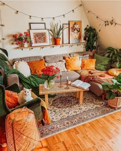 a living room filled with lots of furniture and plants on top of the couches