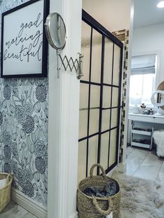 a bathroom with a wallpapered pattern and a basket on the floor next to it