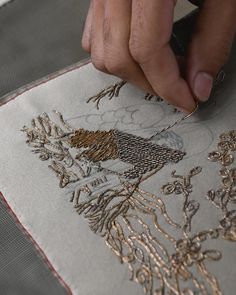 a person is working on an embroidered piece