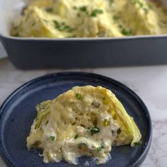 an egg casserole on a blue plate next to a baking dish