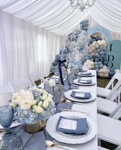 the table is set with blue and white decorations