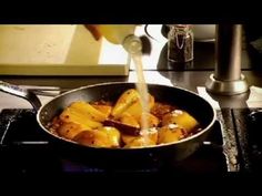 a pan filled with food on top of a stove