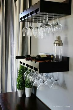 there is a wine glass rack on the wall