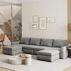 a living room with a sectional couch and coffee table in front of the stair case