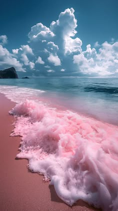 pink foamy water on the beach under a cloudy sky