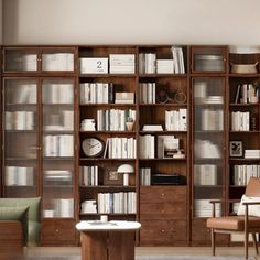 a living room filled with lots of furniture and bookshelves next to a couch