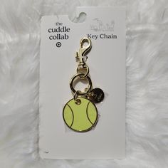 a key chain with a tennis ball on it