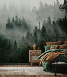 a bed room with a neatly made bed next to a forest wall mural