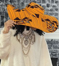 African print hat features a wide range of authentic African prints, each bursting with rich, bold colors and intricate patterns that reflect the diverse tapestry of African cultures. The design of the hat is modern and stylish, with a classic shape that suits various face shapes and hairstyles. African print hat is crafted from high-quality Original African patterns 100% cotton One size fits for all Especially great for all-season outings Modern and stylish design It's versatile same print inside and outside It's the perfect look for your summer vacation, weekend getaway, beach or pool party, or for a trip to the Islands. It's unisex, making it a fantastic choice for anyone who wants to celebrate African fashion. Orange Beach Hats One Size Fits Most, Orange Beach Hats, One Size Fits Most, Orange Beach Hat, One Size Fits Most, Orange Beach Hat One Size Fits Most, Orange Beach Hat With Curved Brim, Orange Vacation Hat, One Size Fits Most, Orange Adjustable Wide Brim Sun Hat, Adjustable Wide Brim Orange Sun Hat, Yellow Flat Brim Bucket Hat For Beach