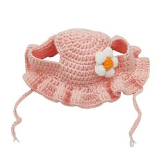 a pink crocheted hat with a flower on it