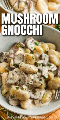 mushroom gnocchini in a white bowl on a wooden table with a fork