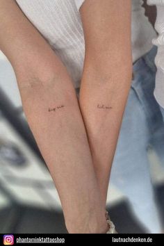 two people with matching tattoos on their arms