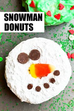 a snowman doughnut with candy on top