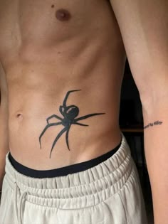 a man with a spider tattoo on his stomach